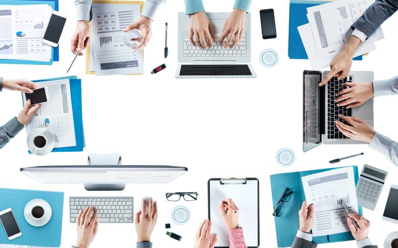 Business team meeting and working at office desk, hands top view, unrecognizable people, blank copy space